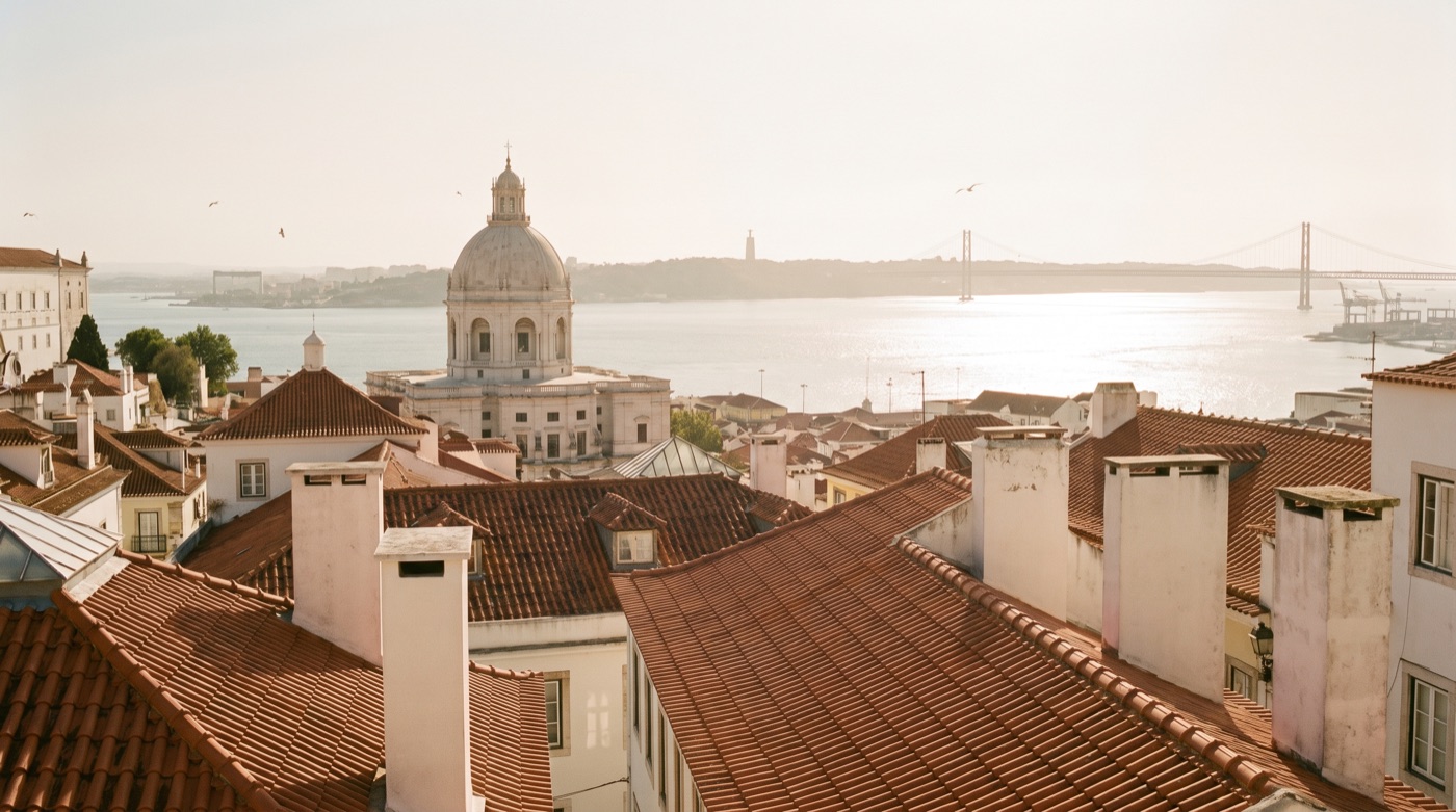 Golden hour over Lisbon rooftops and the Tejo river