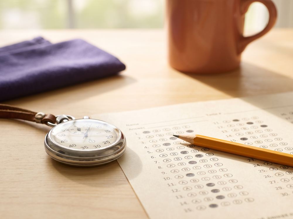 Stopwatch and pencil on a multiple-choice answer sheet